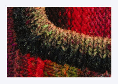Wie man eine vertikal gestreifte Weste strickt